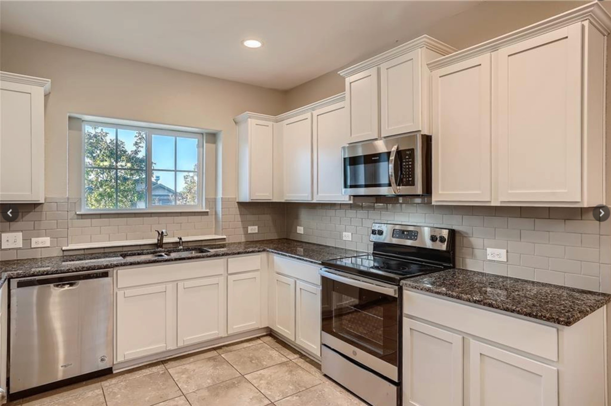 304 Cane River Road Pflugerville, TX 78660 - Photo 6 of 31 Culinary delights await in this bright kitchen, complete with generous counter space and contemporary appliances.