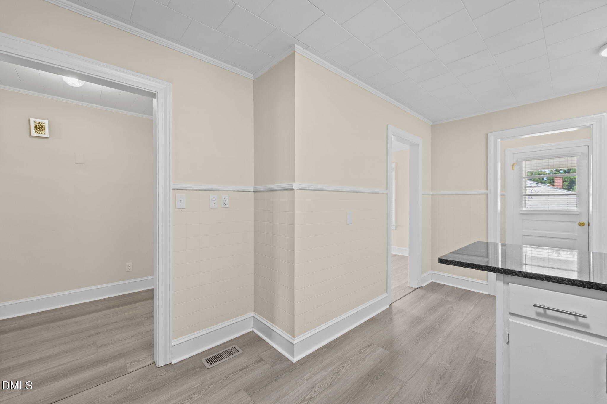 1723 Power Line Road Elon, NC 27244 - Photo 11 of 22 an empty room with wooden floor cabinet and windows