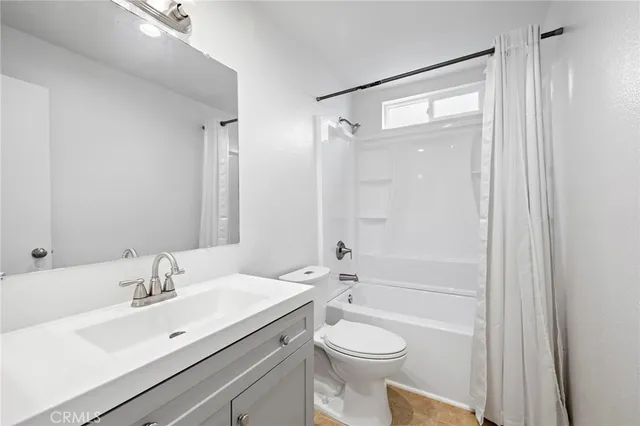 a view of room with window and wooden floor