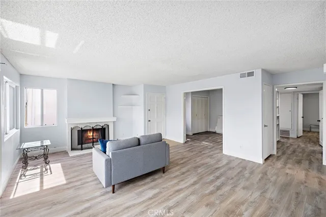 a kitchen with white cabinets appliances a sink and a window