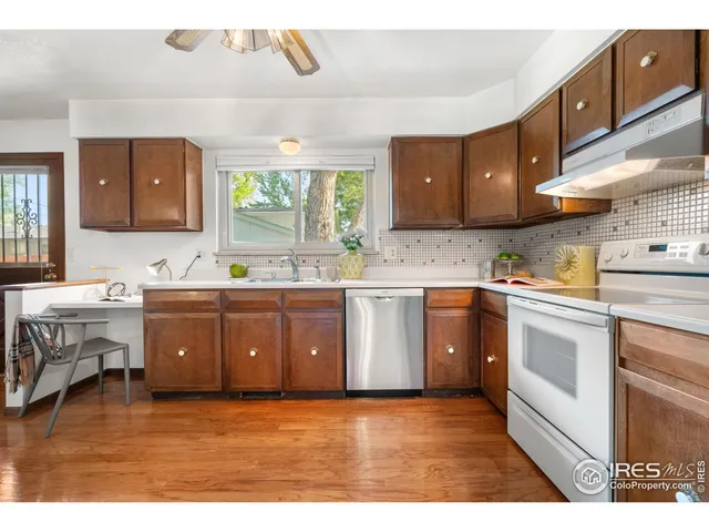 a kitchen with a sink cabinets and window