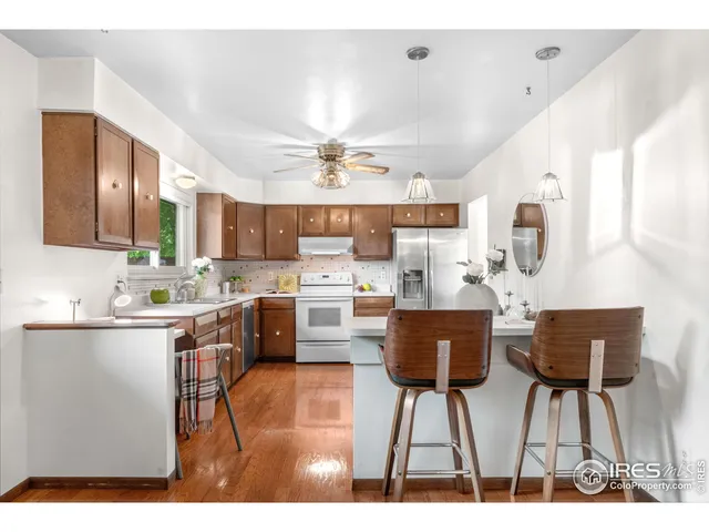 a kitchen with stainless steel appliances kitchen island granite countertop a sink and cabinets