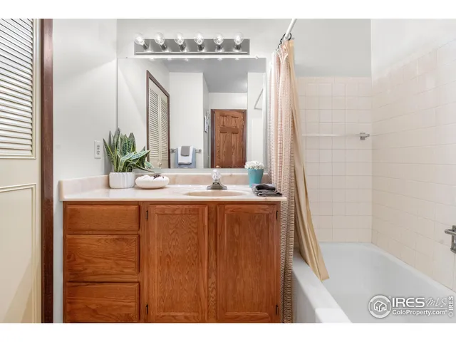 a bathroom with a bathtub sink and mirror