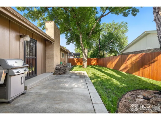 a backyard of a house with dishwasher and a garden
