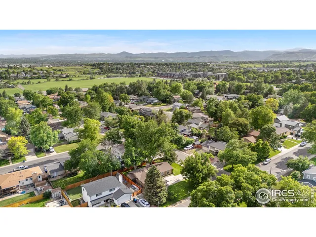 a view of a city with lush green forest