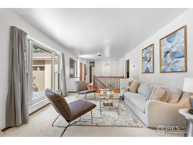 a living room with furniture or couch and a large window