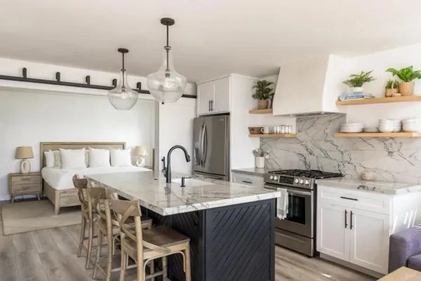 a kitchen with stainless steel appliances a sink stove and cabinets