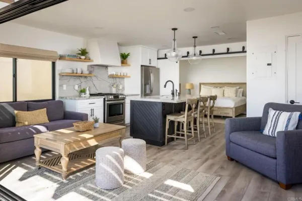 a living room with kitchen island furniture a kitchen view and appliances