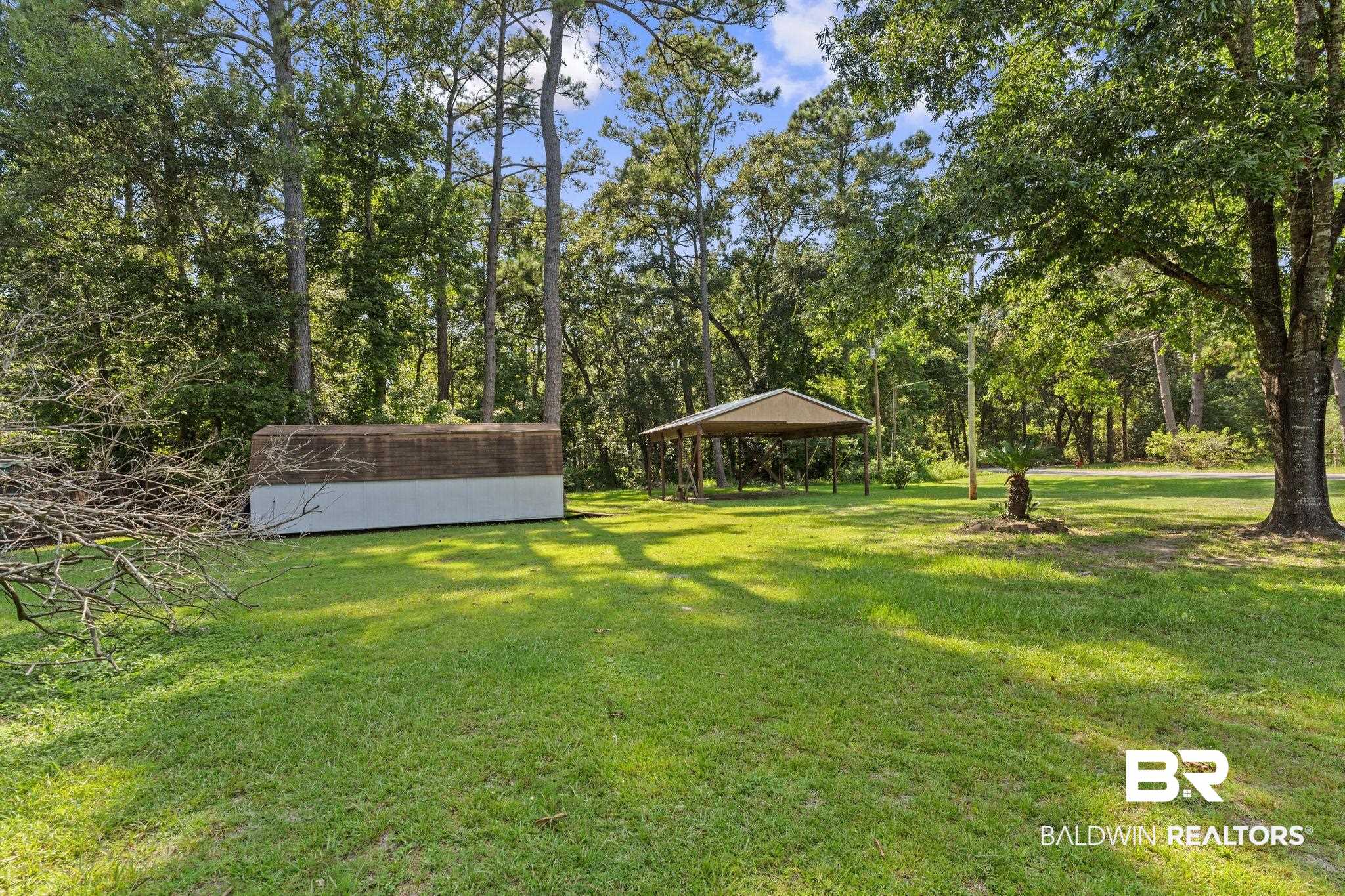 14095 Riverside Drive Foley, AL 36535 - Photo 27 of 30 View of green lawn with a gazebo, a shed, and a detached carport