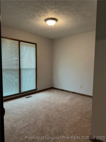 an empty room with closet area