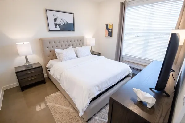a bedroom with a bed and a night stand