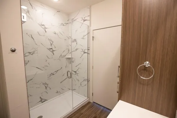 a bathroom with a shower and a sink