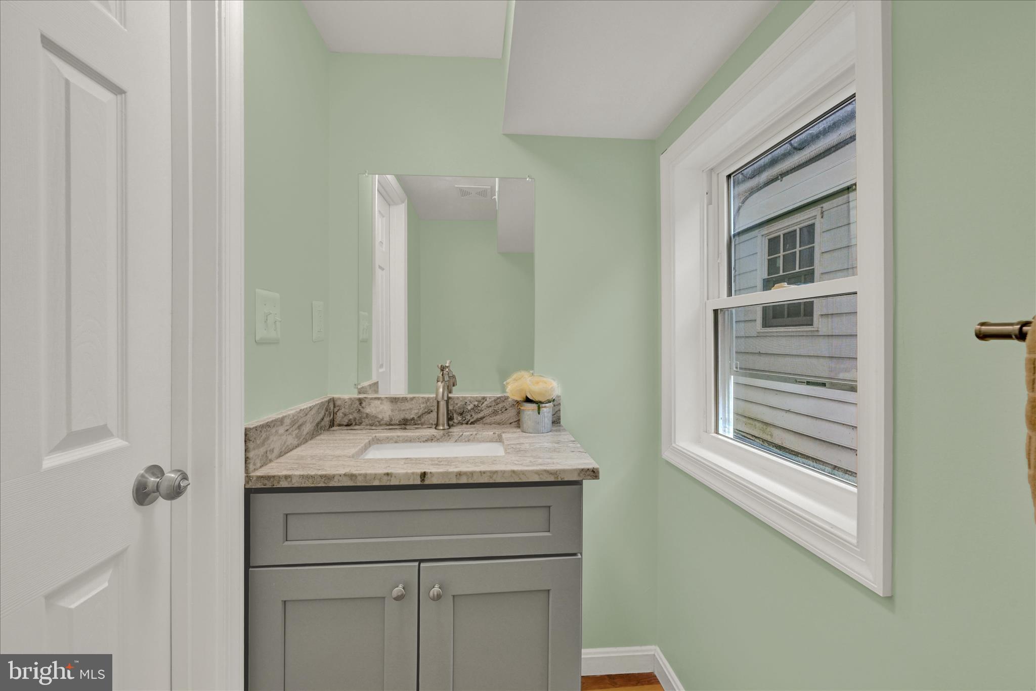8511 Frederick Road Ellicott City, MD 21043 - Photo 13 of 36 a bathroom with a granite countertop sink and a mirror