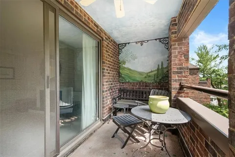 a view of room with painting on the wall and a window