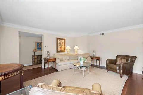 a living room with furniture fireplace and a large window