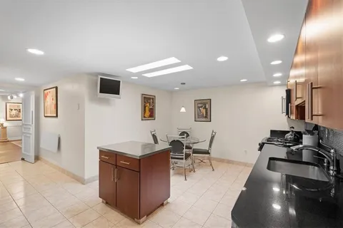 a kitchen with stainless steel appliances granite countertop a stove top oven a sink dishwasher and a refrigerator