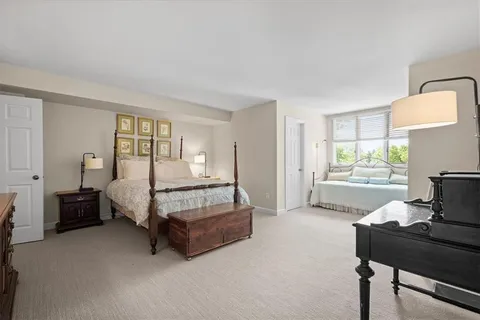 a spacious bedroom with a bed and window