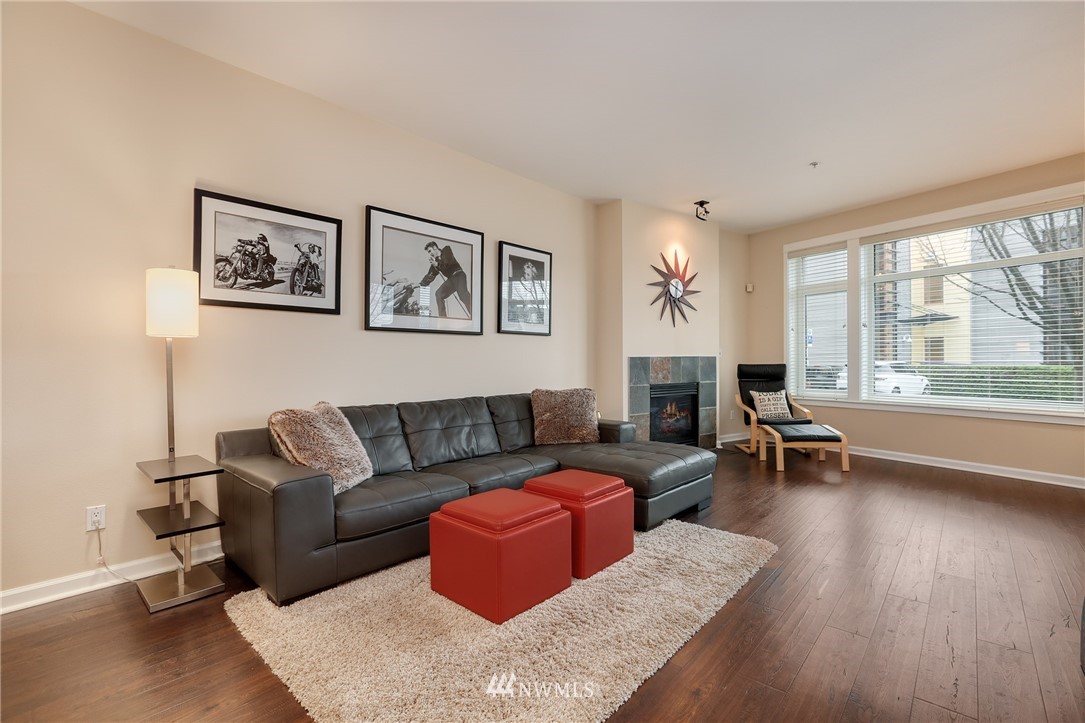 1900 Alaskan Way, Unit 105 Seattle, WA 98101 - Photo 1 of 1 a living room with furniture and a large window