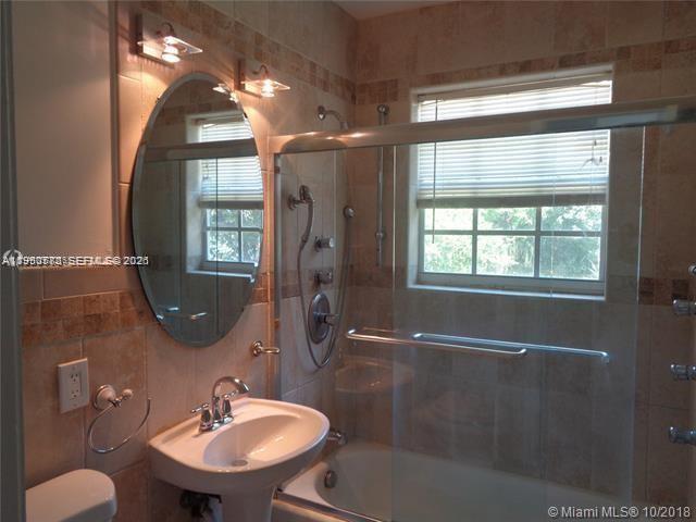 1925 Thomas Street, Unit 1925 Hollywood, FL 33020 - Photo 19 of 24 a bathroom with a sink toilet and shower