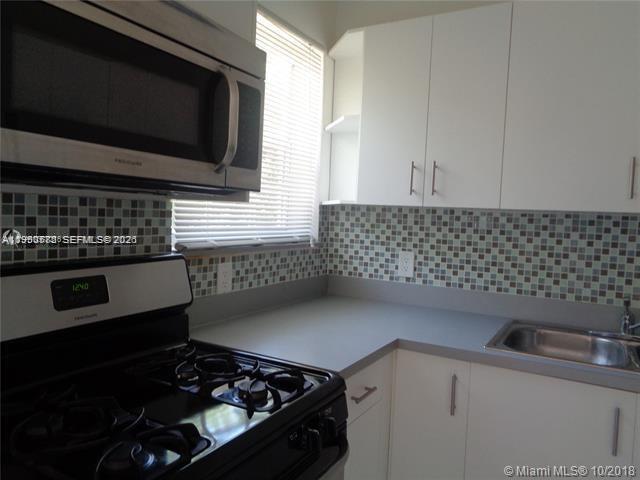 1925 Thomas Street, Unit 1925 Hollywood, FL 33020 - Photo 2 of 24 a kitchen with a stove and a microwave