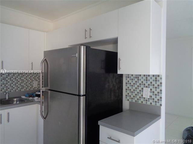 1925 Thomas Street, Unit 1925 Hollywood, FL 33020 - Photo 3 of 24 a kitchen with metallic refrigerator freezer and a dishwasher