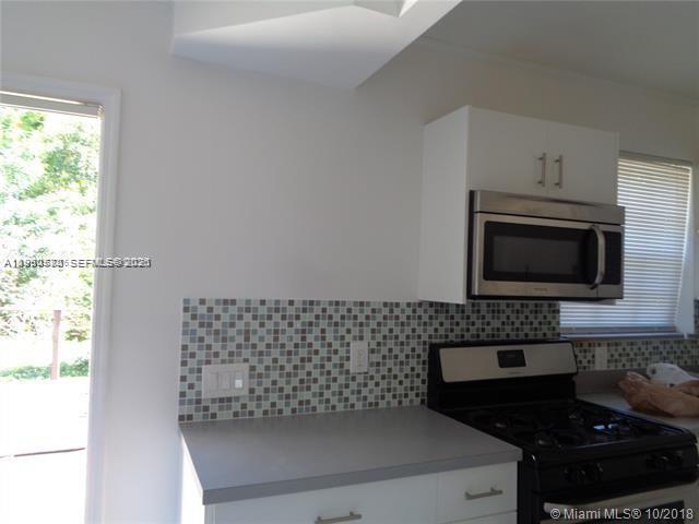 1925 Thomas Street, Unit 1925 Hollywood, FL 33020 - Photo 4 of 24 a kitchen with a sink and a stove top oven