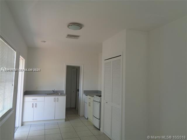 1925 Thomas Street, Unit 1925 Hollywood, FL 33020 - Photo 6 of 24 a kitchen with a refrigerator and cabinets