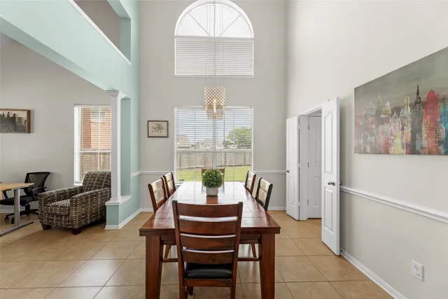 a dining room with furniture window and wooden floor