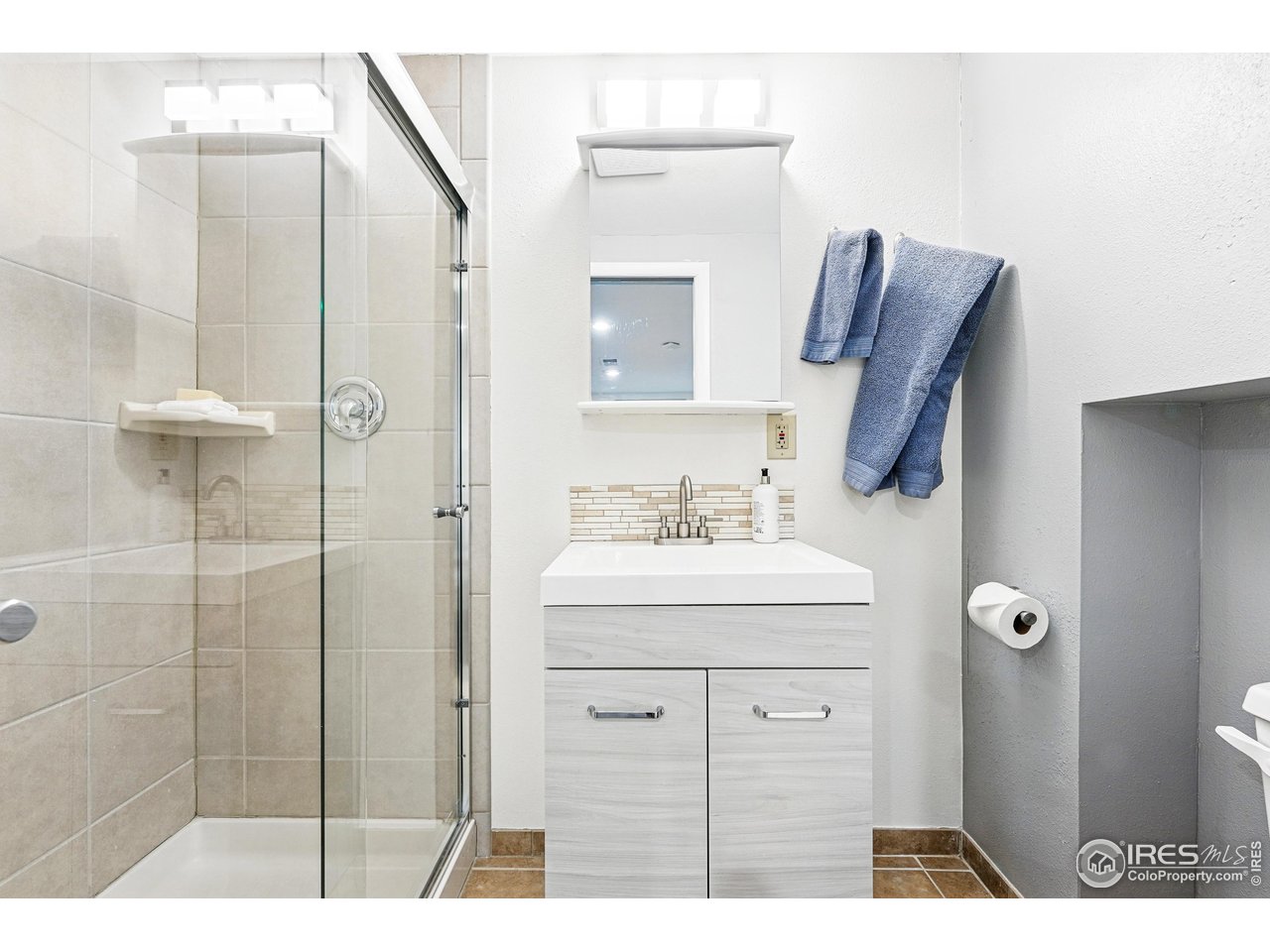 803 Ithaca Drive Boulder, CO 80305 - Photo 30 of 35 a bathroom with a sink a toilet and shower