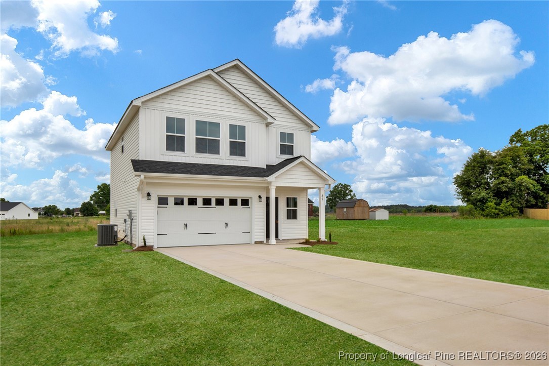 253 Barberry Road Raeford, NC 28376 - Photo 2 of 31 a large white house with a big yard and large trees