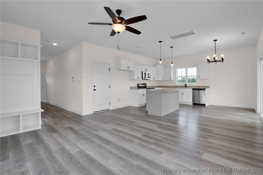 253 Barberry Road Raeford, NC 28376 - Photo 6 of 31 a view of a kitchen with a sink and wooden floor