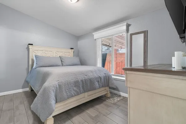 a bed sitting in a bedroom next to a window