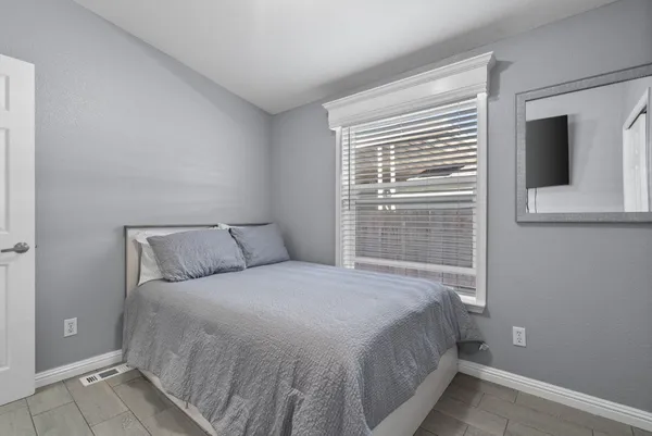 a bedroom with a bed and a window