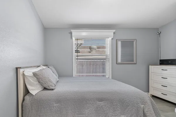 a bedroom with a bed and a window