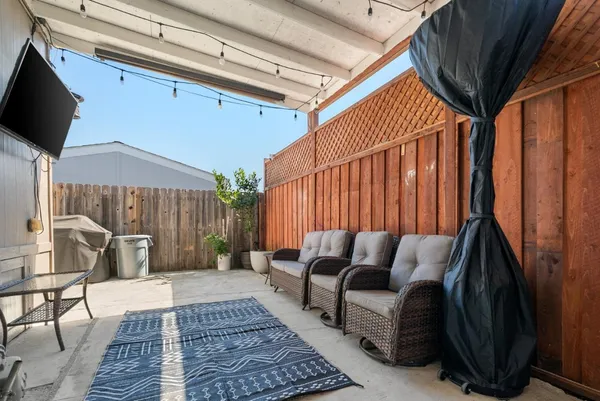 a balcony with furniture and a potted plant