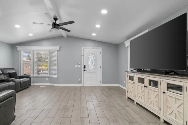 a kitchen with a stove and a wooden floor
