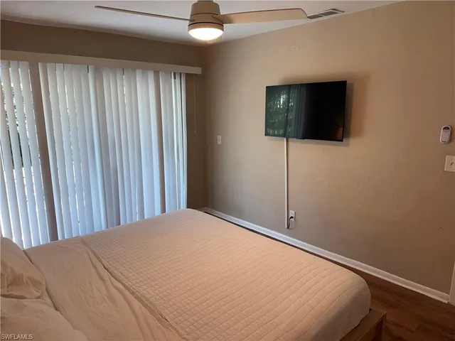 a bed room with a bed and a television