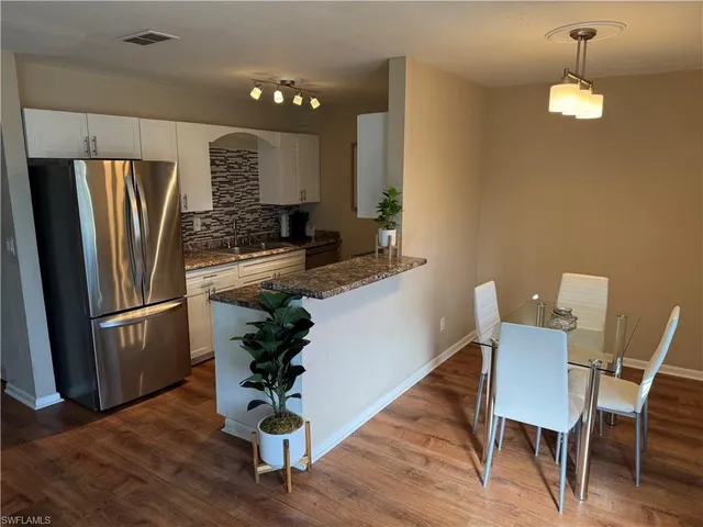 a kitchen with a table and chairs