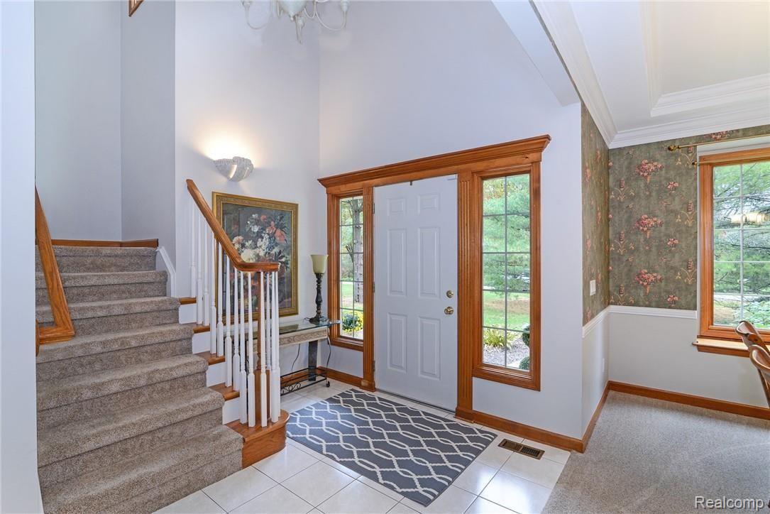 Large open foyer, with ceramic tile and gorgeous woodwork 