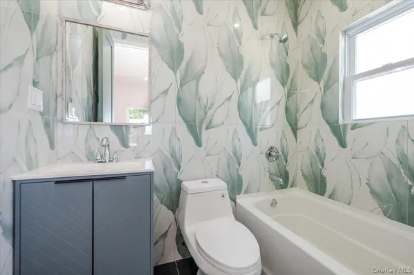 a bathroom with a sink a toilet and a bathtub