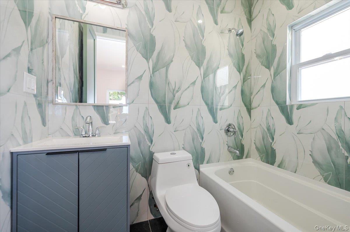 10709 220th Street Queens, NY 11429 - Photo 13 of 14 a bathroom with a sink a toilet and a bathtub
