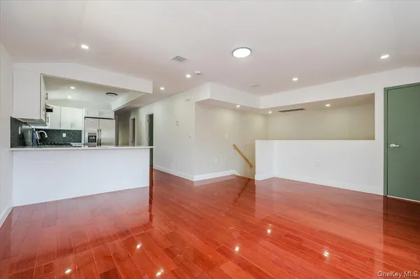 a view of kitchen with refrigerator and window