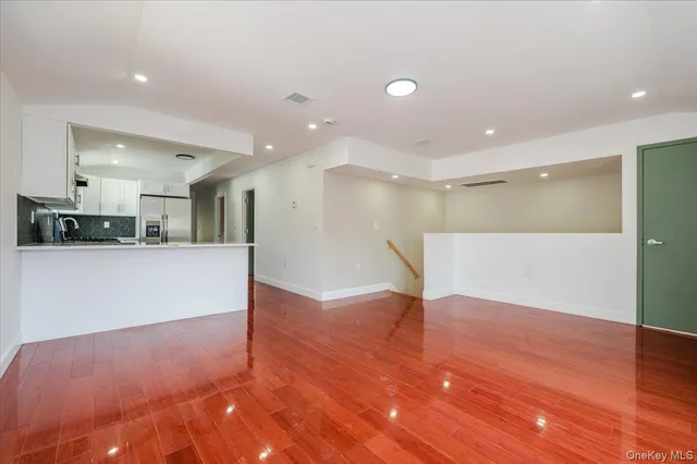 a view of kitchen with refrigerator and window