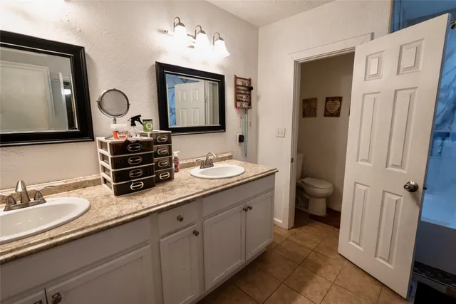 a bathroom with 2 sink and a mirror