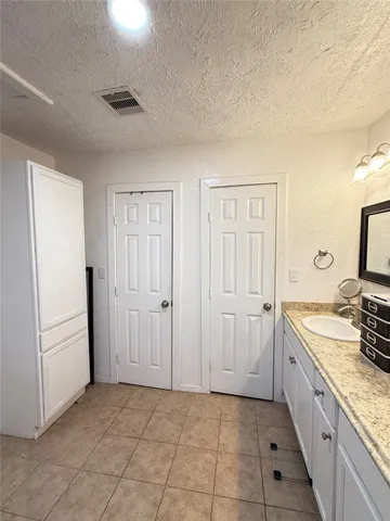 a spacious bathroom with a double vanity sink and a mirror