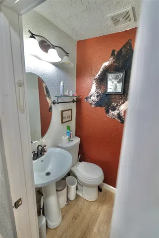 a bathroom with a toilet and a mirror