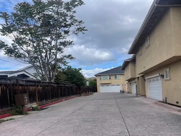 a view of house with backyard and sitting area