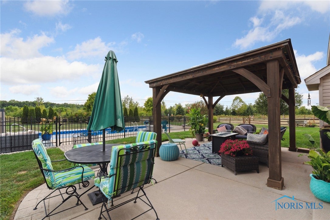 166 Lawai Road Oregon, OH 43616 - Photo 36 of 48 Large concrete patio with gazebo.