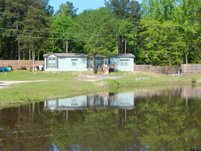 a backyard of a house with yard and outdoor seating