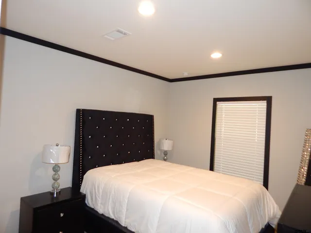 a bedroom with a bed and a flat screen tv